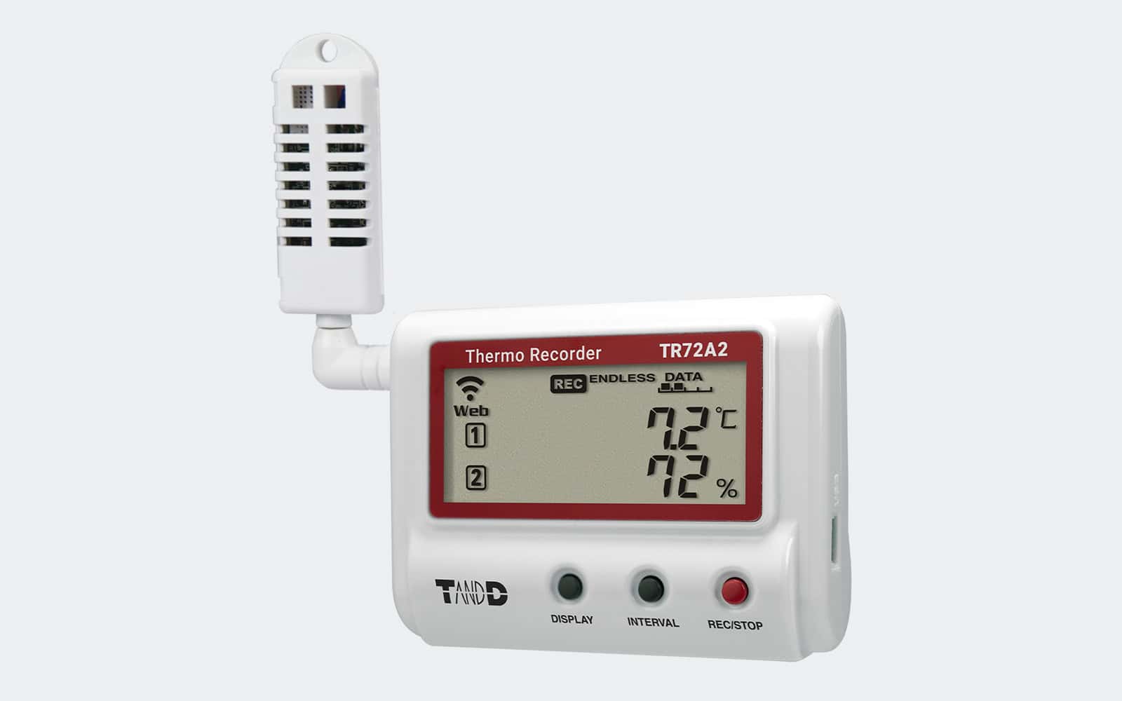 Registrador de temperatura y humedad T&D TR72A2 con pantalla digital y sensor externo, diseñado para monitorización ambiental en tiempo real sobre fondo gris claro
